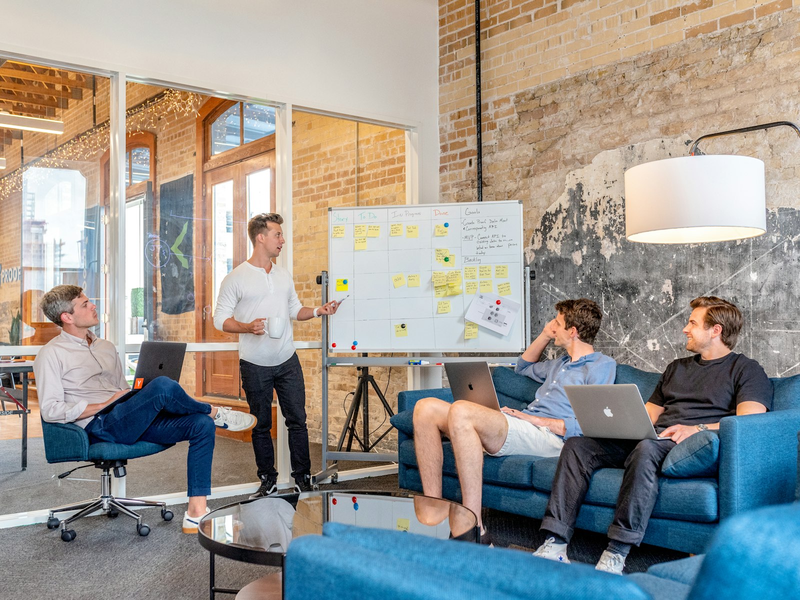 Digital marketing agency team reviewing a campaign plan at a whiteboard